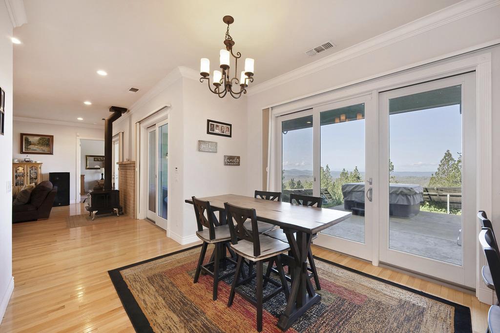5901 Traverse Creek Road Garden Valley, CA 95633 - Photo 42 of 98 a view of a dining room with furniture window and wooden floor