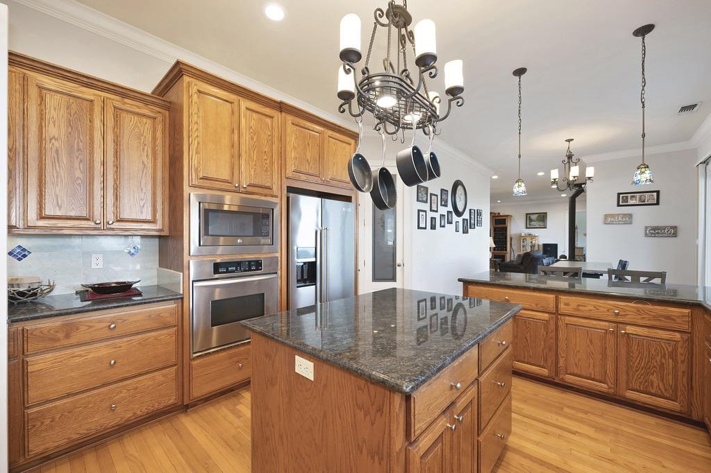 5901 Traverse Creek Road Garden Valley, CA 95633 - Photo 46 of 98 a kitchen with stainless steel appliances granite countertop a sink a refrigerator and cabinets