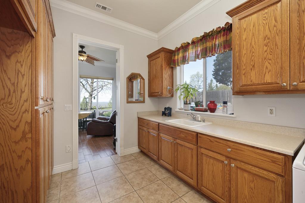 5901 Traverse Creek Road Garden Valley, CA 95633 - Photo 49 of 98 a kitchen with a sink and cabinets