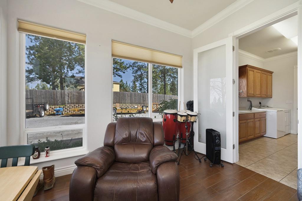 5901 Traverse Creek Road Garden Valley, CA 95633 - Photo 56 of 98 sitting room featuring ornamental molding, dark wood-style floors, and washer / dryer
