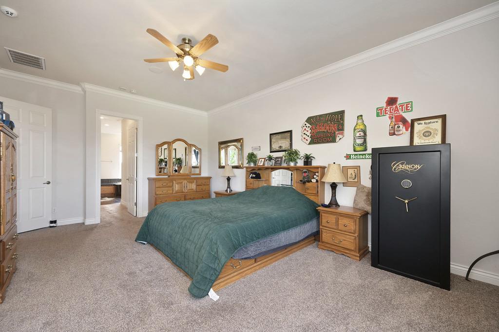 5901 Traverse Creek Road Garden Valley, CA 95633 - Photo 58 of 98 bedroom with crown molding, carpet, and ceiling fan