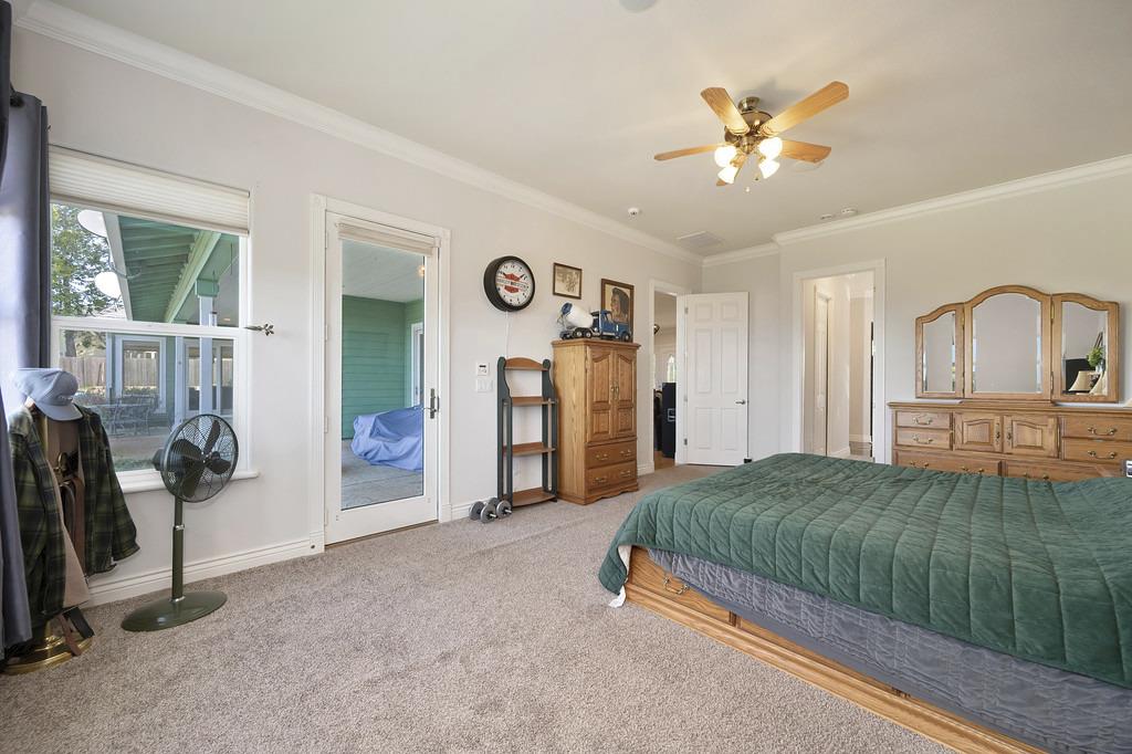 5901 Traverse Creek Road Garden Valley, CA 95633 - Photo 59 of 98 a bedroom with a bed and a chandelier