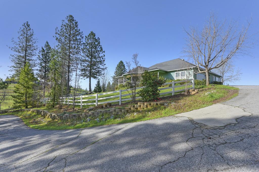 5901 Traverse Creek Road Garden Valley, CA 95633 - Photo 6 of 98 a front view of a house with a yard and garage