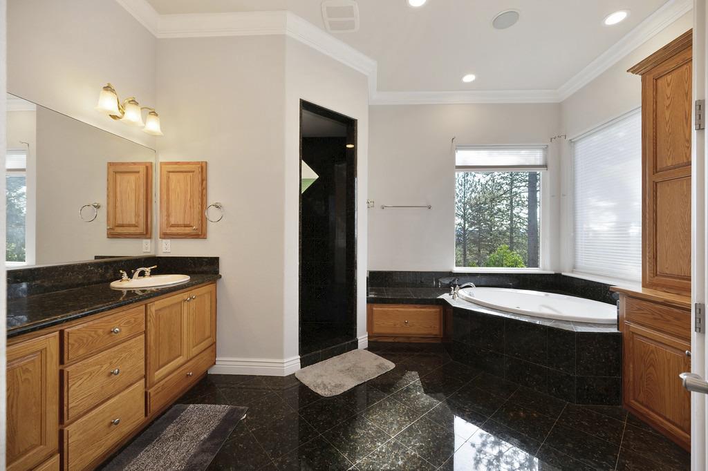 5901 Traverse Creek Road Garden Valley, CA 95633 - Photo 61 of 98 full bathroom featuring granite tiled floors, crown molding, vanity, a bath, and recessed lighting