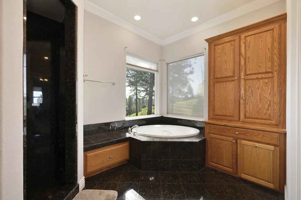 5901 Traverse Creek Road Garden Valley, CA 95633 - Photo 62 of 98 full bathroom with granite floors, ornamental molding, a bath, a shower stall, and recessed lighting