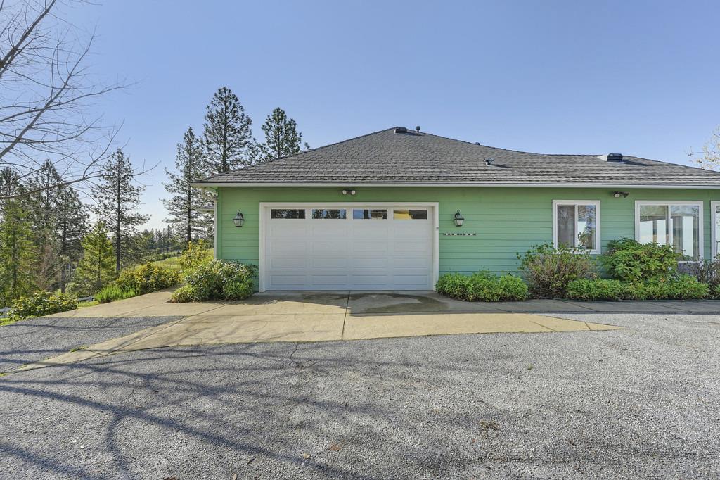5901 Traverse Creek Road Garden Valley, CA 95633 - Photo 64 of 98 a front view of a house with a yard and garage