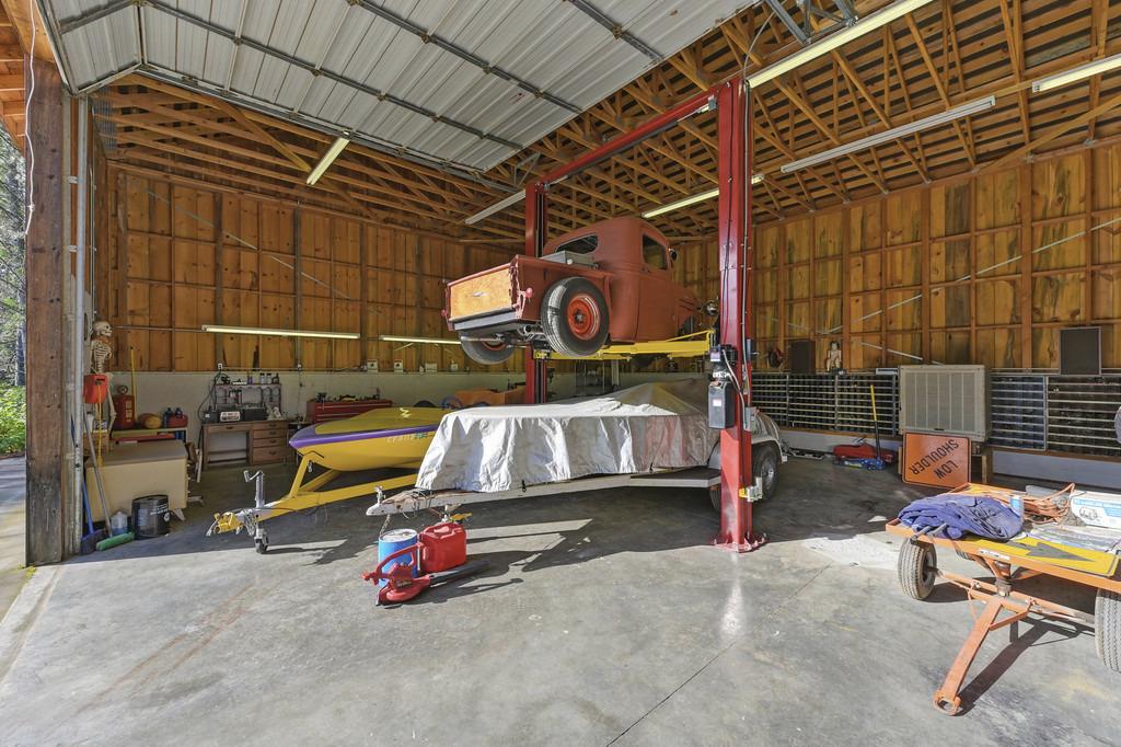 5901 Traverse Creek Road Garden Valley, CA 95633 - Photo 73 of 98 a backyard of a house with barbeque oven table and chairs