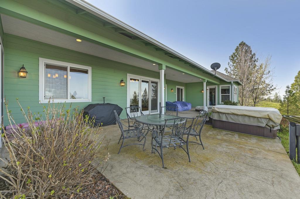 5901 Traverse Creek Road Garden Valley, CA 95633 - Photo 87 of 98 a view of a patio with table and chairs and potted plants