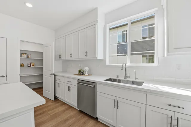 a kitchen with cabinets appliances and a sink