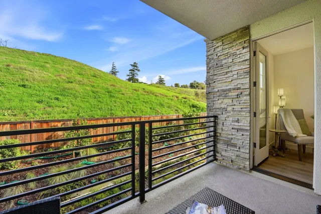 a bedroom with furniture and a large window