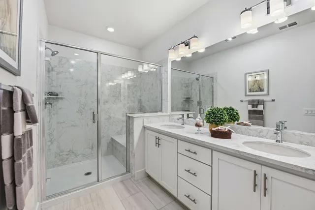 a bathroom with a sink a large mirror and a toilet