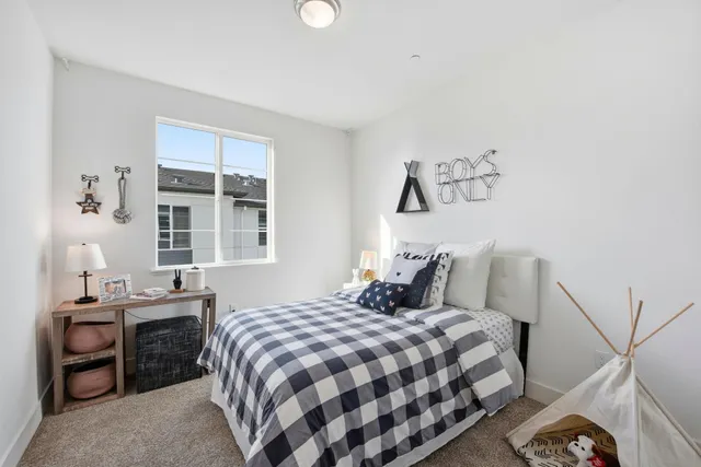 a bedroom with a bed and a chandelier