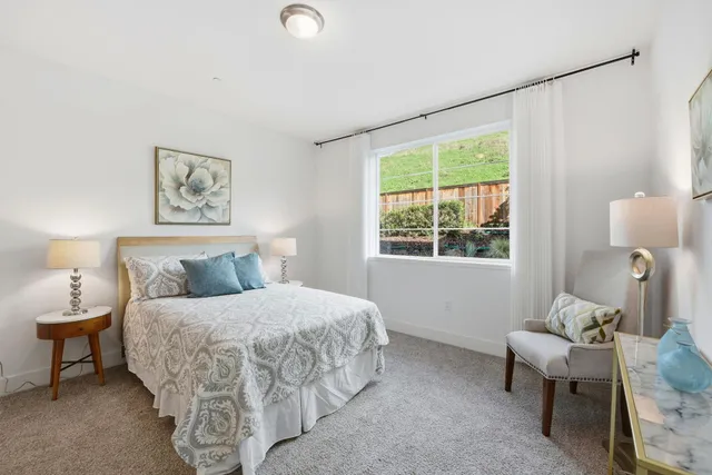 a bedroom with a bed and a couch