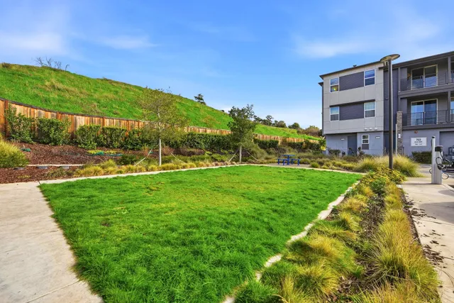 a view of house with garden space and swimming pool