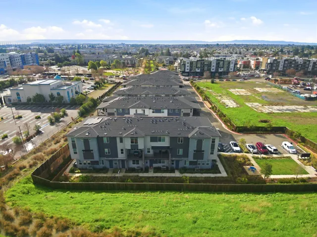 an aerial view of residential houses with outdoor space