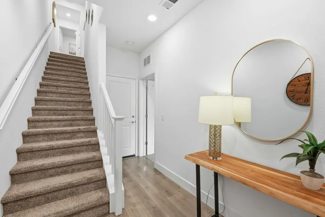 a view of entryway and hall with wooden floor