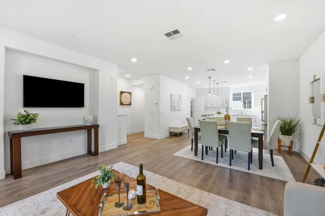 a living room with furniture wooden floor and a flat screen tv