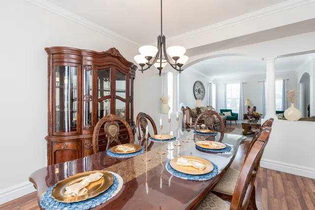 a kitchen with a stove a sink a refrigerator and a dining table