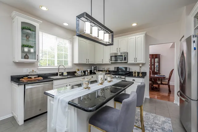 a view of a dining room with furniture and a chandelier