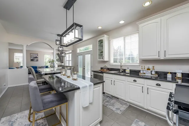 a kitchen with a center island appliances and cabinets