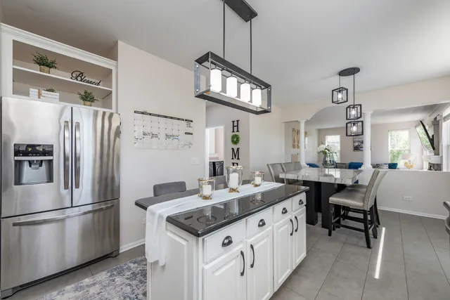 a kitchen with stainless steel appliances granite countertop a sink stove and cabinets