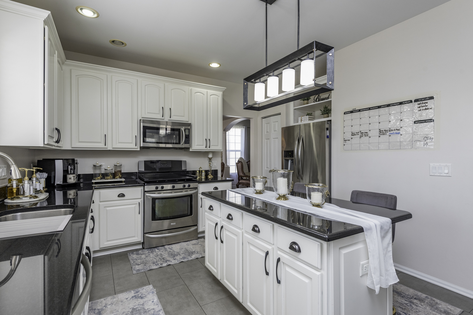 1650 Natures Way Lindenhurst, IL 60046 - Photo 17 of 55 a kitchen with stainless steel appliances granite countertop a sink stove and cabinets
