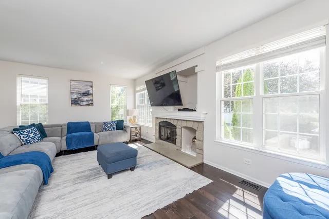 a living room with couches and a night stand