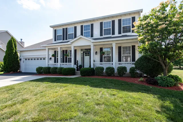 a front view of a house with garden and porch