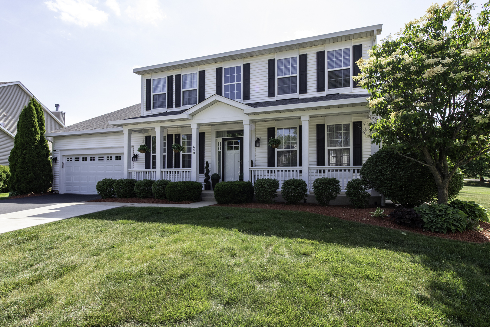 1650 Natures Way Lindenhurst, IL 60046 - Photo 2 of 55 a front view of a house with garden and porch