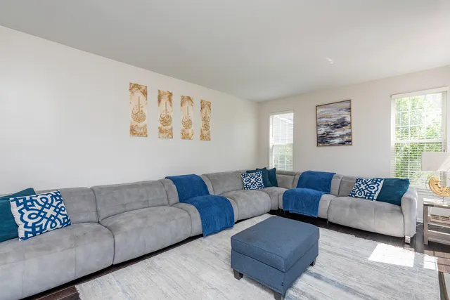 a living room with furniture and kitchen view