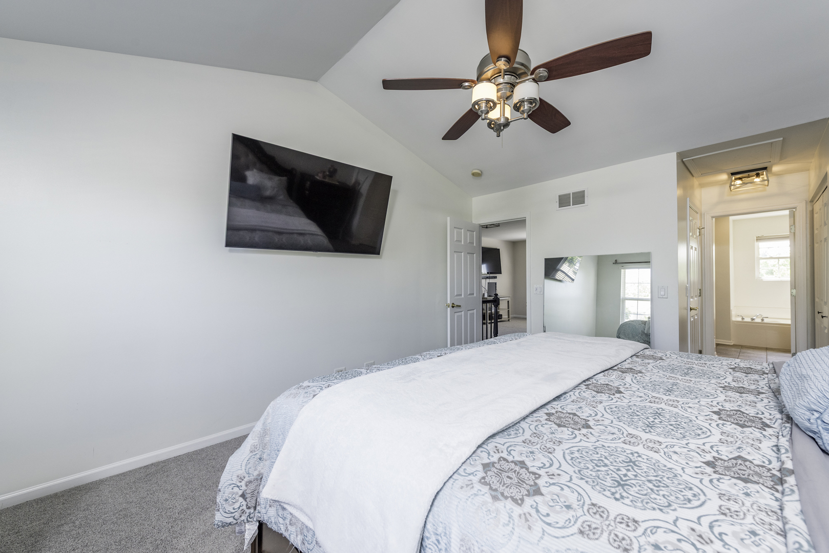 1650 Natures Way Lindenhurst, IL 60046 - Photo 27 of 55 a spacious bedroom with a bed and a chandelier