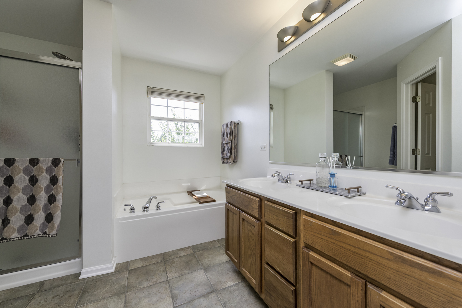 1650 Natures Way Lindenhurst, IL 60046 - Photo 28 of 55 a spacious bathroom with a double vanity sink mirror and bathtub