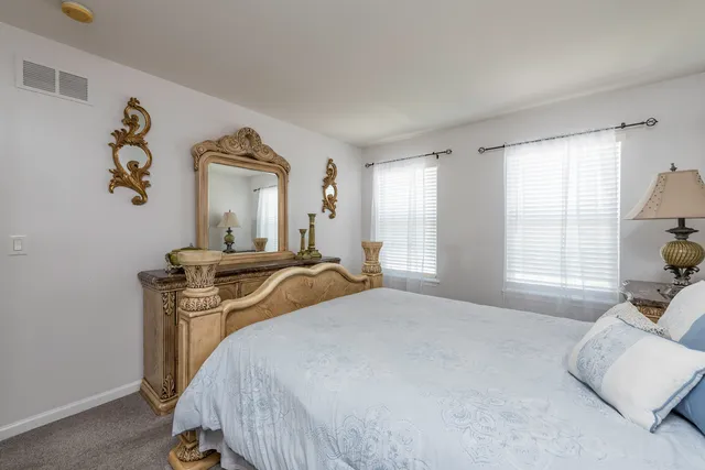 a bedroom with a bed and a tv on the dresser