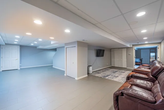 a room with gym equipment and wooden floor