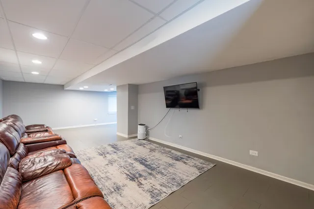 a view of a porch with furniture and a yard