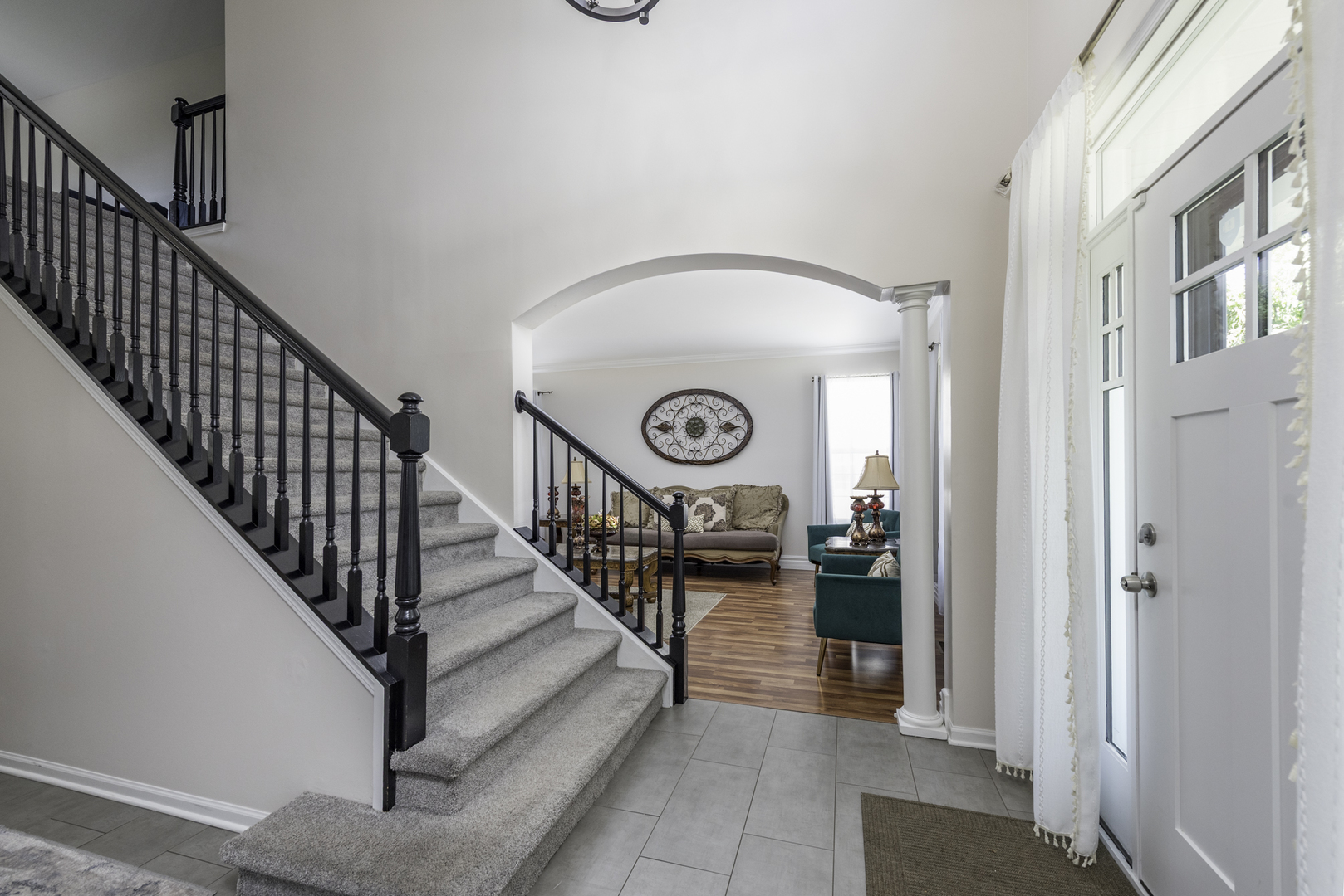 1650 Natures Way Lindenhurst, IL 60046 - Photo 4 of 55 a view of staircase with lots of frames on wall and a window