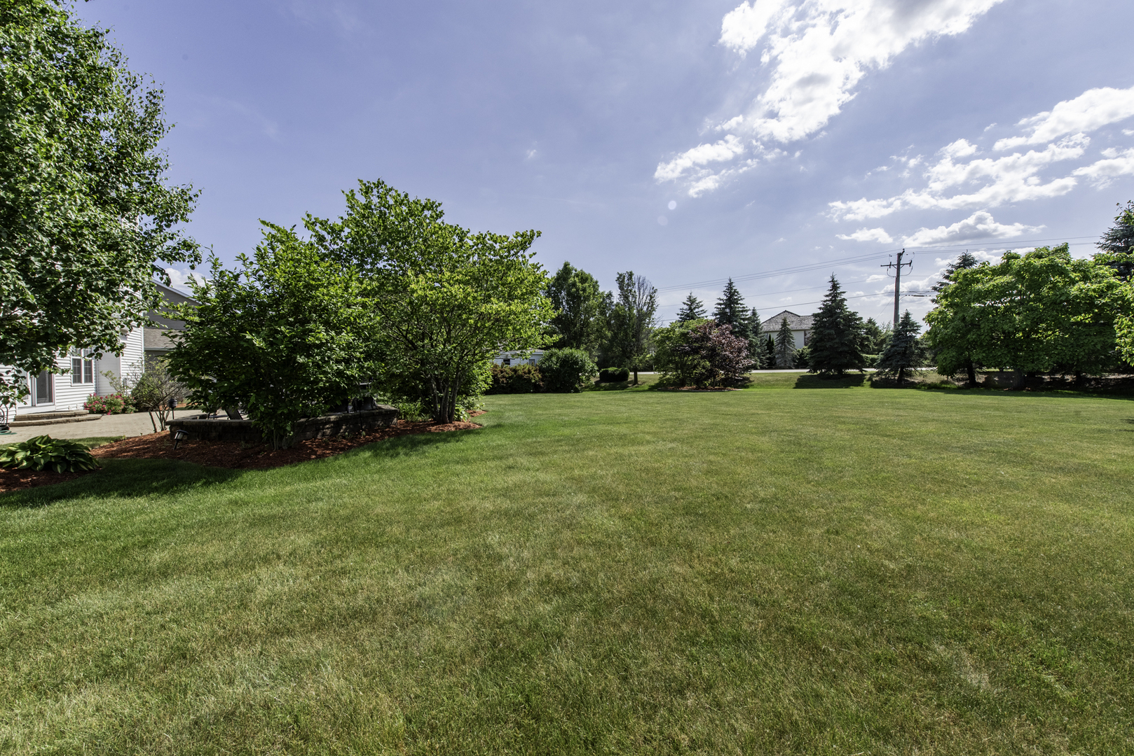 1650 Natures Way Lindenhurst, IL 60046 - Photo 55 of 55 a view of a green field with trees in the background