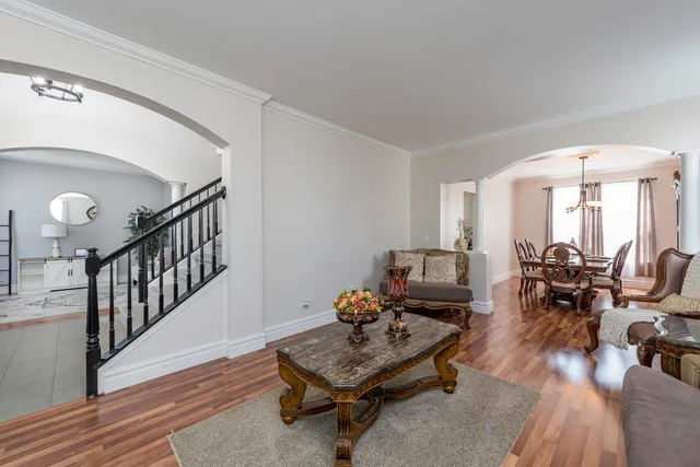 a living room with furniture a rug and a large window