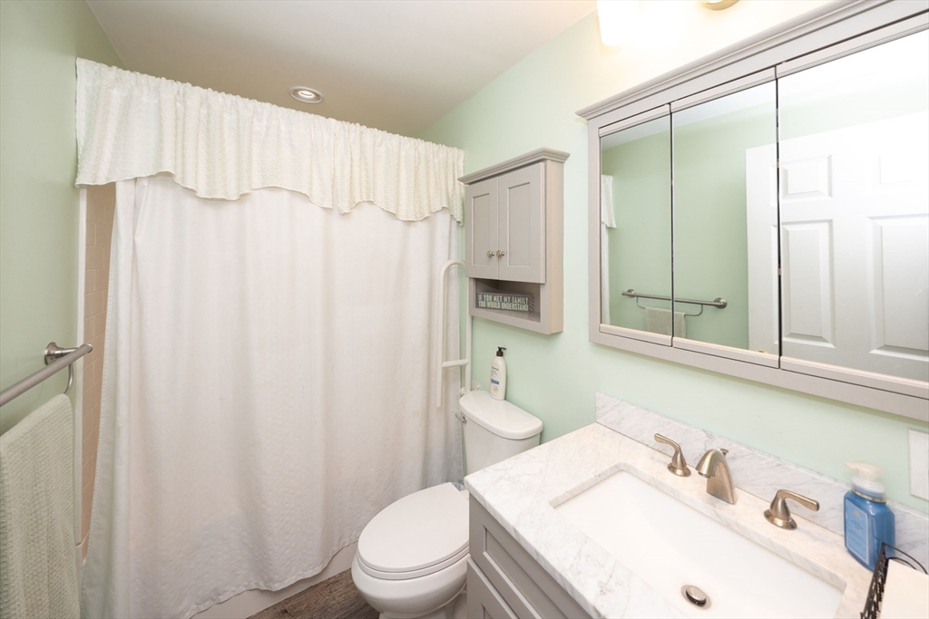 1195 Grafton Street, Unit 19 Worcester, MA 01604 - Photo 14 of 22 a bathroom with a sink a toilet and shower curtain