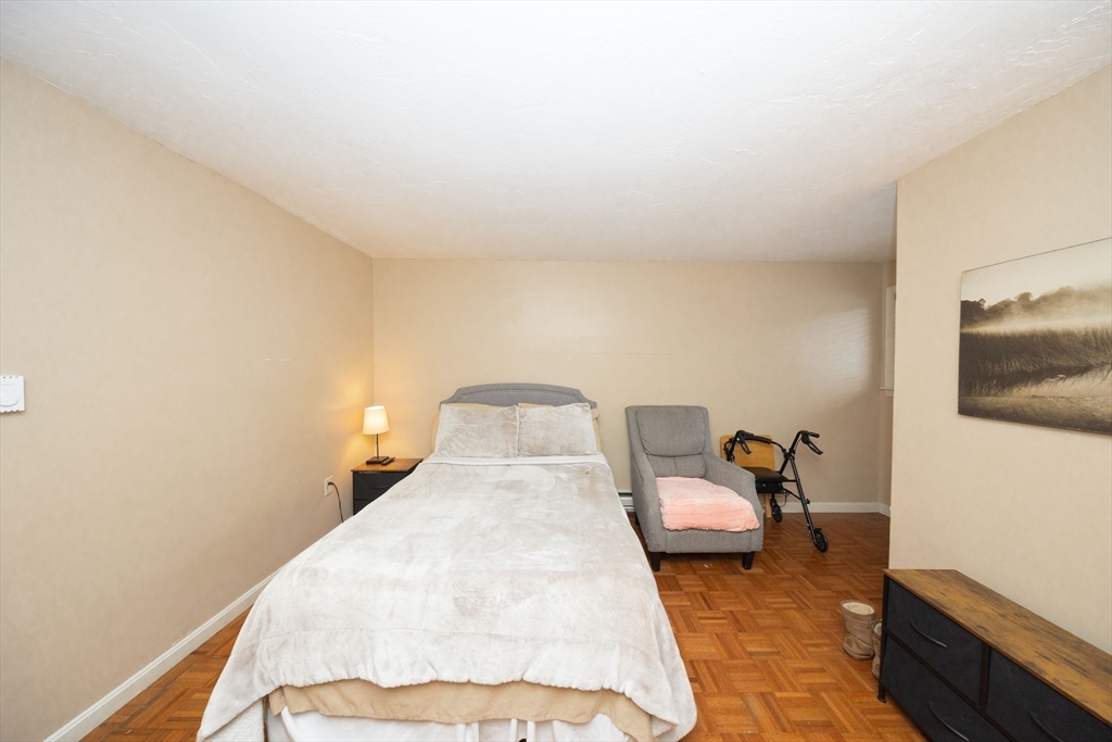 1195 Grafton Street, Unit 19 Worcester, MA 01604 - Photo 16 of 22 a bedroom with a bed and wooden floor