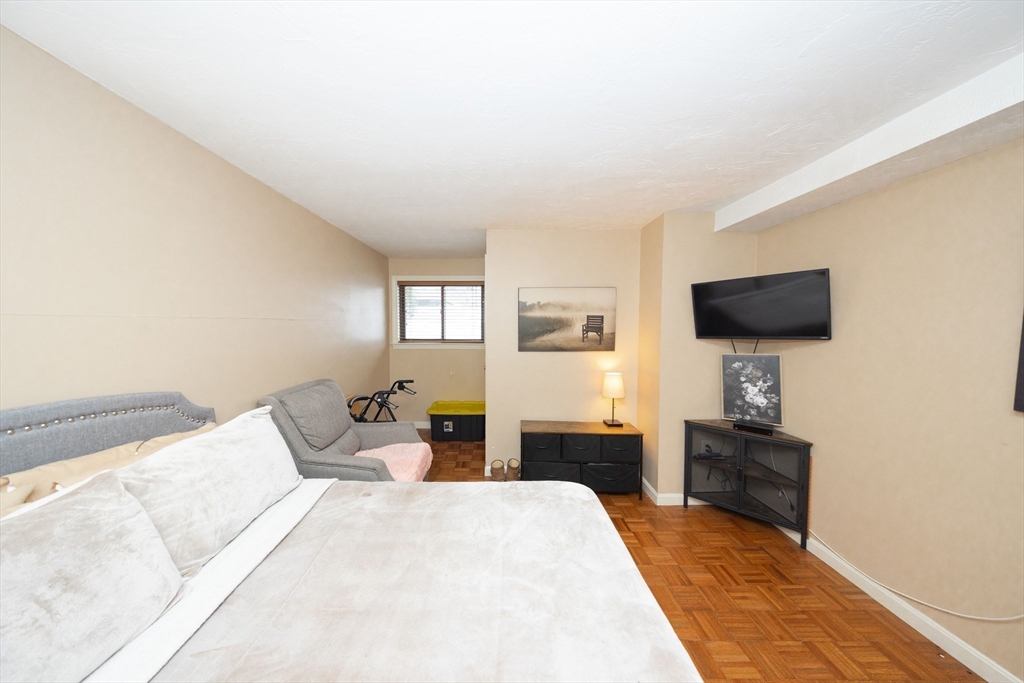 1195 Grafton Street, Unit 19 Worcester, MA 01604 - Photo 18 of 22 a bedroom with a bed and a flat screen tv