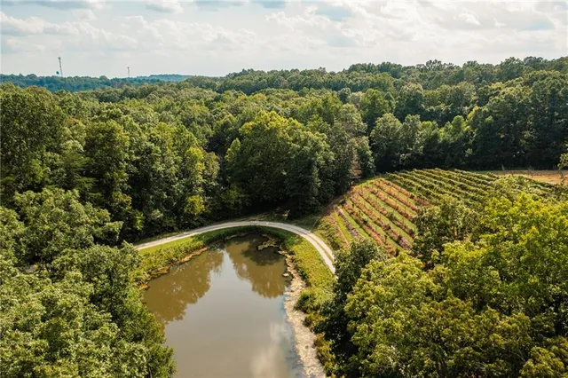 a kitchen with stainless steel appliances granite countertop wooden floors and white cabinets