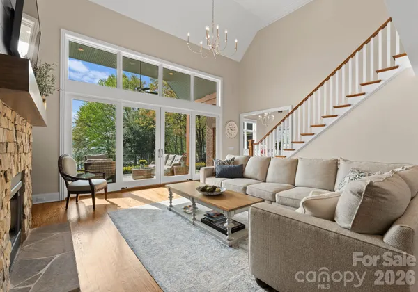 a living room with furniture and floor to ceiling windows