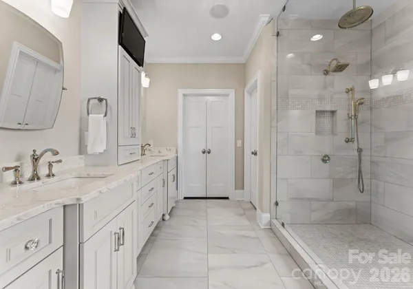 a spacious bathroom with a granite countertop sink mirror and shower