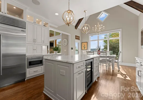 a kitchen with stainless steel appliances granite countertop a stove and cabinets