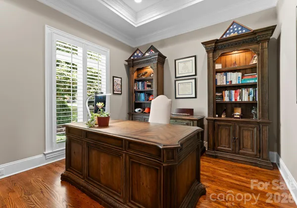 a room with a table chairs and wooden floor