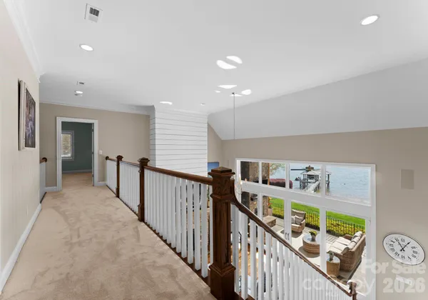 a view of a hallway with bedroom and stairs