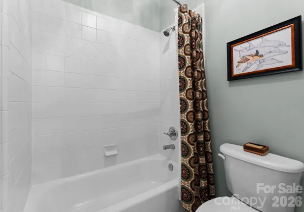 a bathroom with a toilet and a bathtub