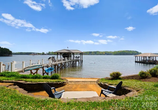a swimming pool with outdoor seating and lake view