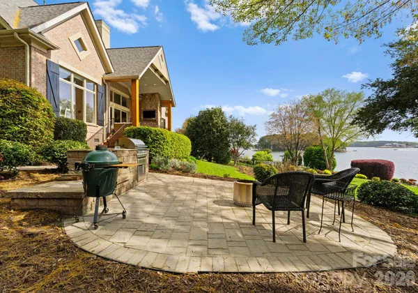 a view of a house with backyard and sitting area